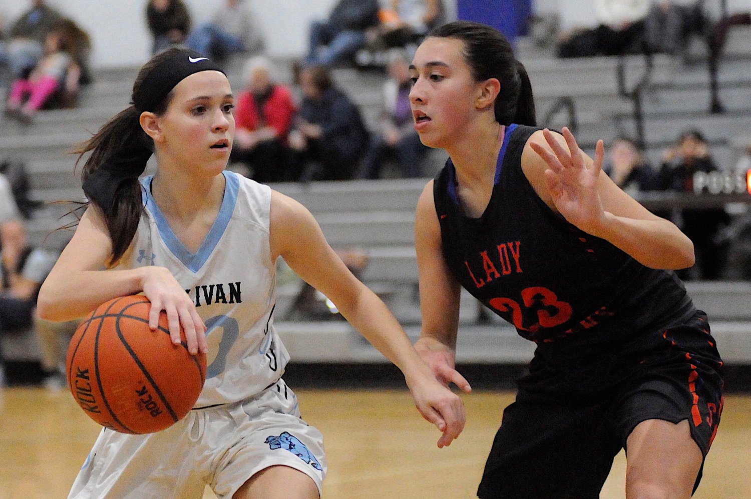 In your face hoops. Sullivan West’s Grace Boyd squares off against Seward’s Shannon Sgambick.
